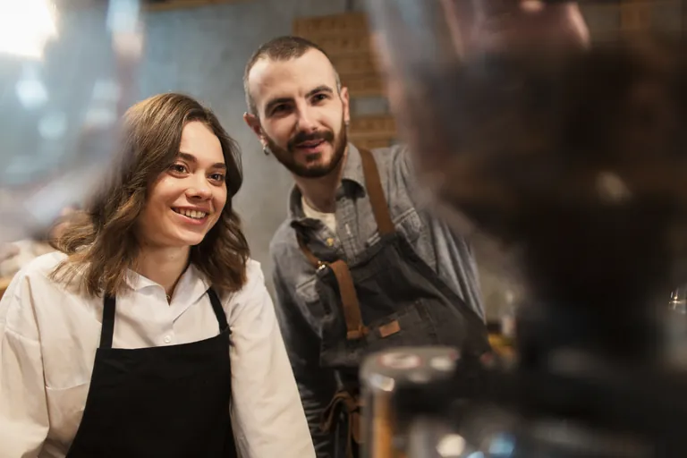 A smiling woman and man working together in a small business